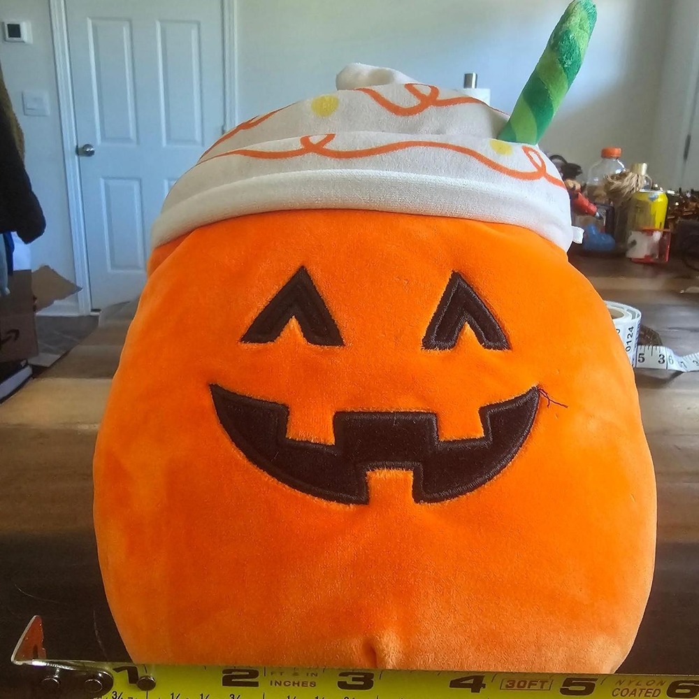 Orange pumpkin plush with black jack-o'-lantern,whipped cream top/ orange swirls